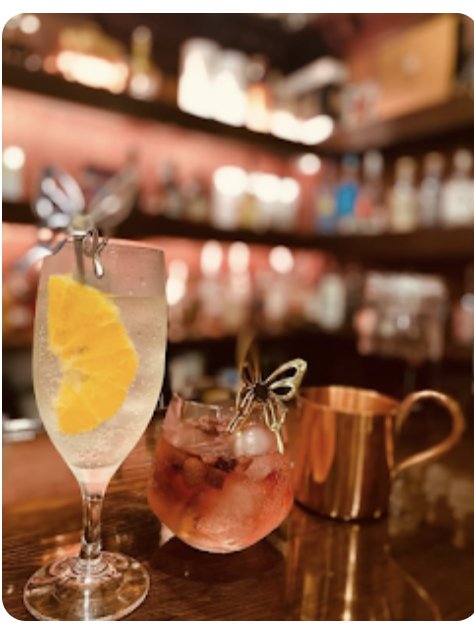 Highball with orange and a cocktail on the counter