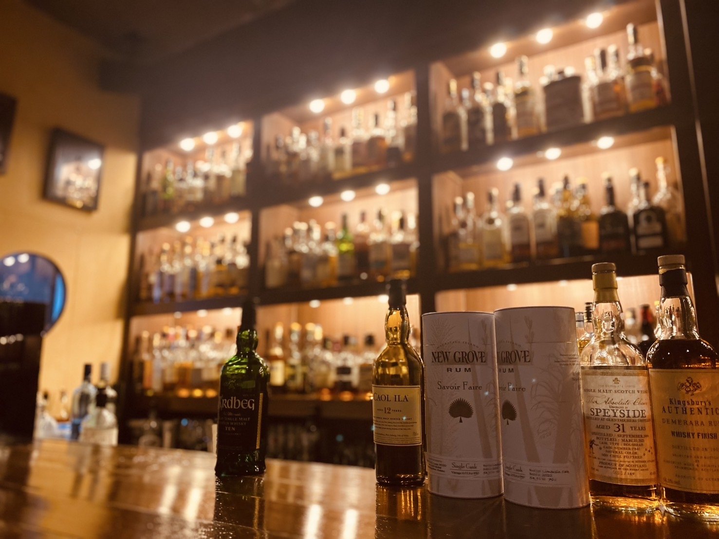 The lit bottle shelves at the main bar
